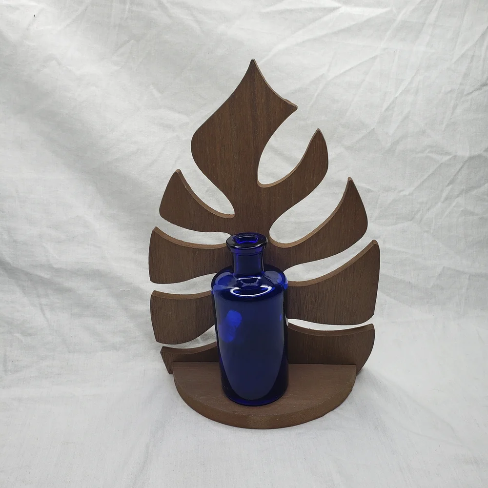 Wood Monstera Leaf Shelf With Blue Glass Vase